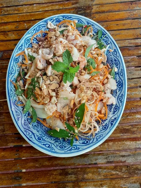 Fresh banana flower salad with beef, herbs, and peanuts