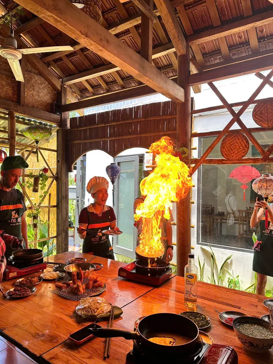 A guest cooking in the open-air kitchen